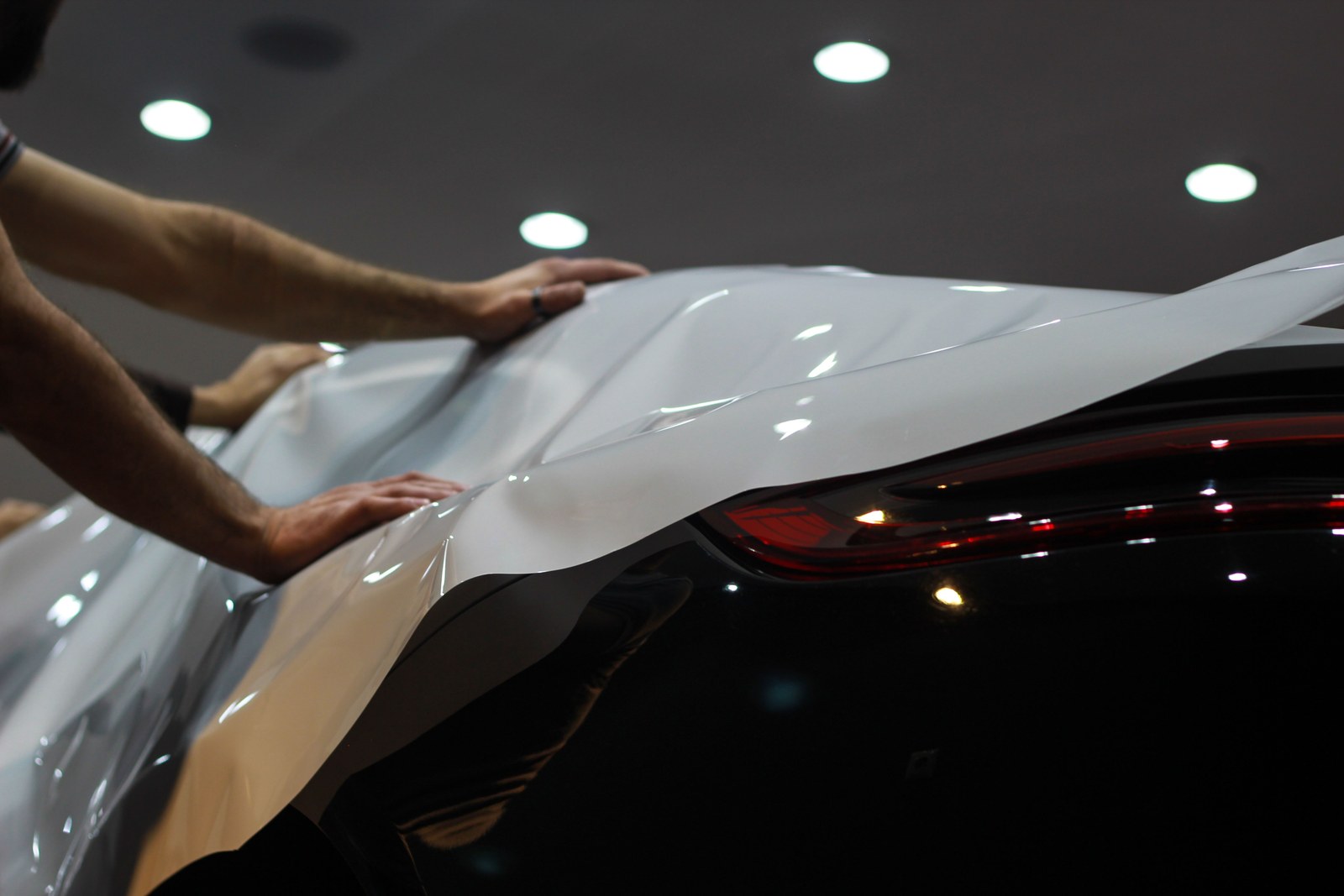 Paint protection film being applied to a vehicle